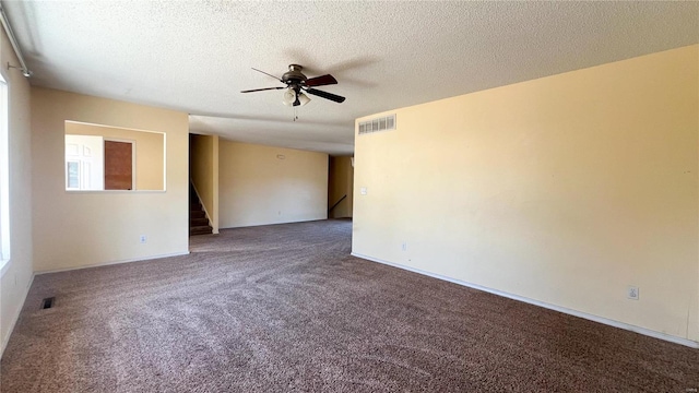 carpeted empty room featuring a textured ceiling and ceiling fan