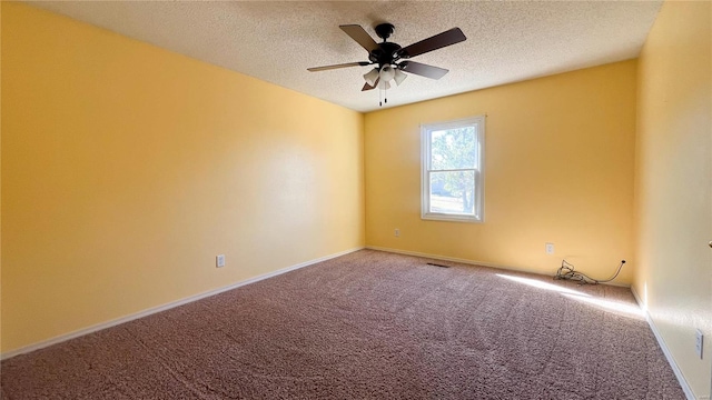 carpeted empty room with a textured ceiling and ceiling fan