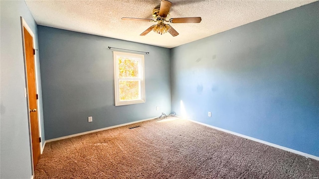 carpeted spare room with ceiling fan and a textured ceiling