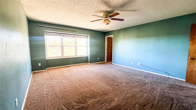 empty room with ceiling fan, carpet flooring, and a textured ceiling