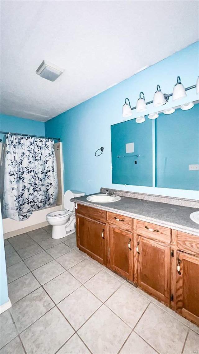 full bathroom featuring vanity, shower / bathtub combination with curtain, toilet, and tile patterned floors