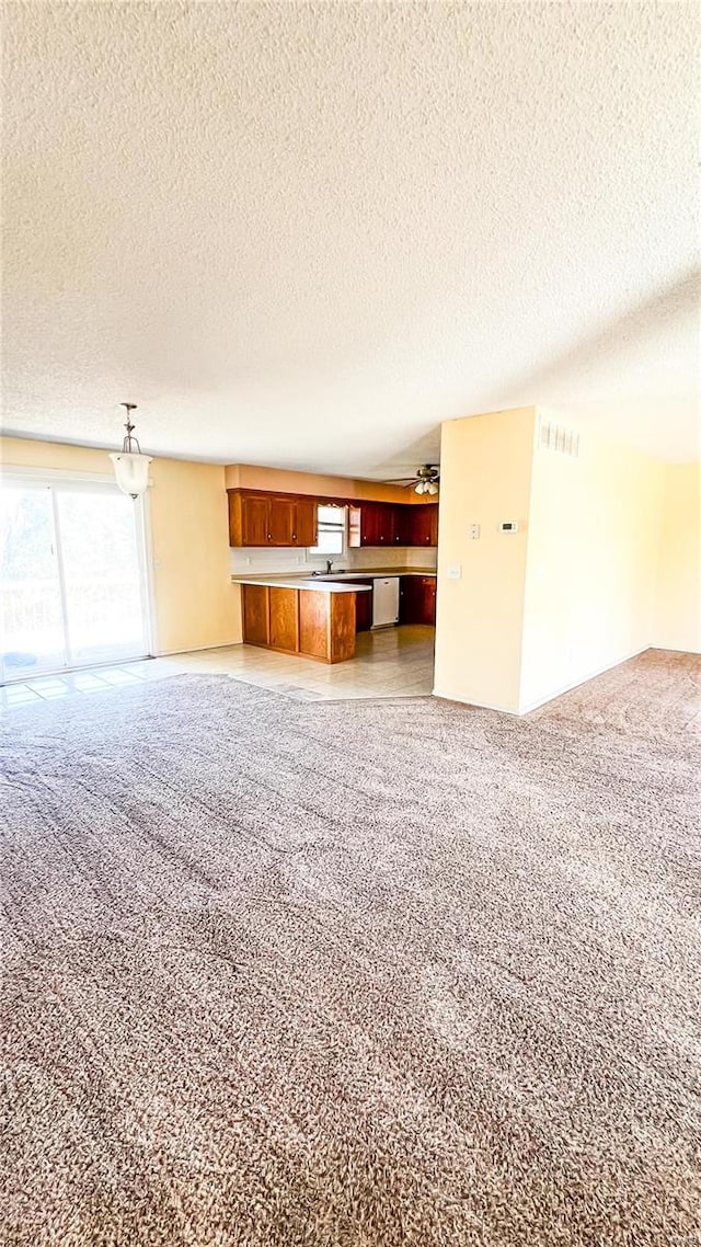 unfurnished living room with a textured ceiling and light colored carpet