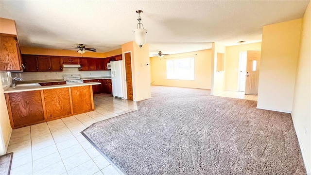 kitchen with hanging light fixtures, light tile patterned floors, a textured ceiling, white appliances, and ceiling fan