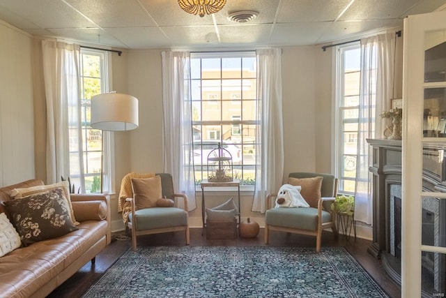 sitting room featuring hardwood / wood-style floors and a paneled ceiling