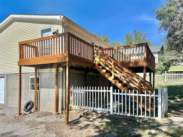 rear view of property featuring a wooden deck