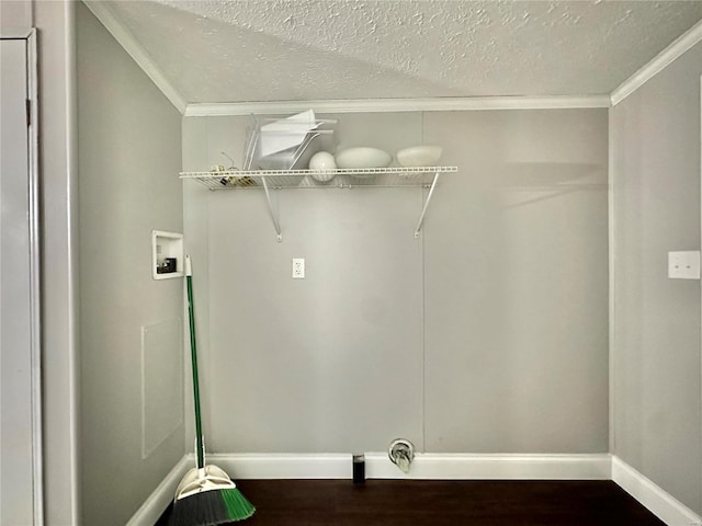 clothes washing area with a textured ceiling, washer hookup, ornamental molding, and dark hardwood / wood-style floors