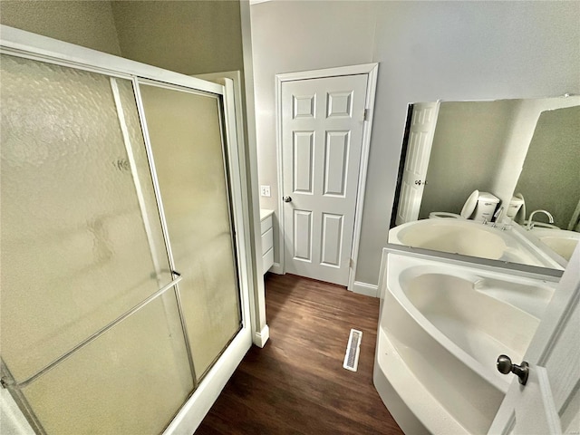 bathroom with vanity, wood-type flooring, and separate shower and tub