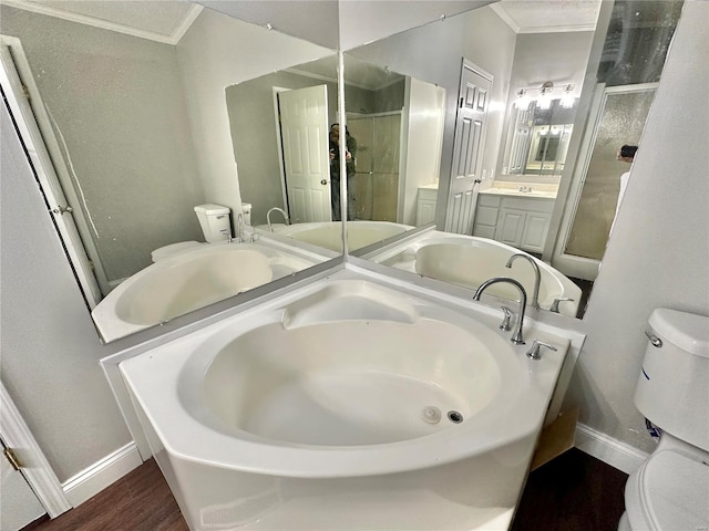 full bathroom featuring plus walk in shower, toilet, hardwood / wood-style floors, crown molding, and vanity