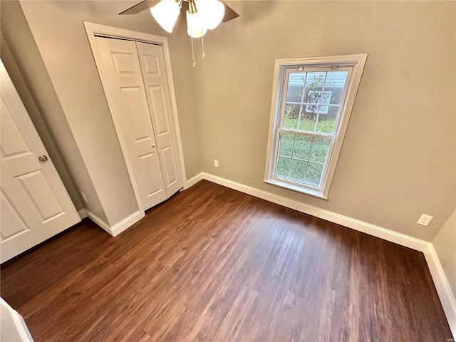 unfurnished bedroom featuring a closet, ceiling fan, and dark hardwood / wood-style floors