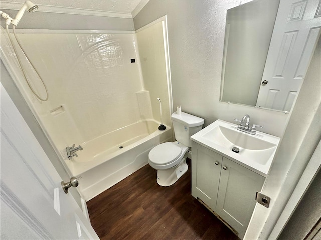 full bathroom with hardwood / wood-style flooring, toilet, tub / shower combination, ornamental molding, and vanity