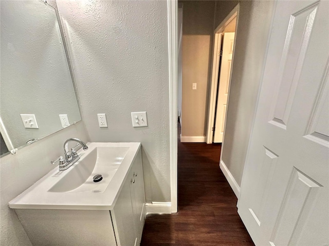 bathroom with vanity and hardwood / wood-style flooring