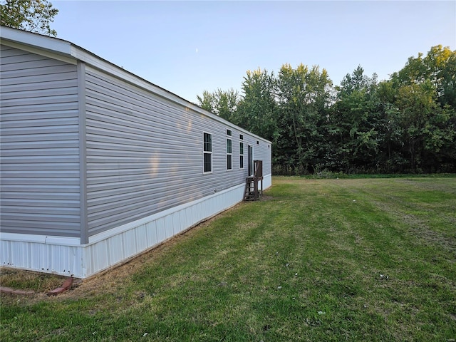 view of property exterior with a yard