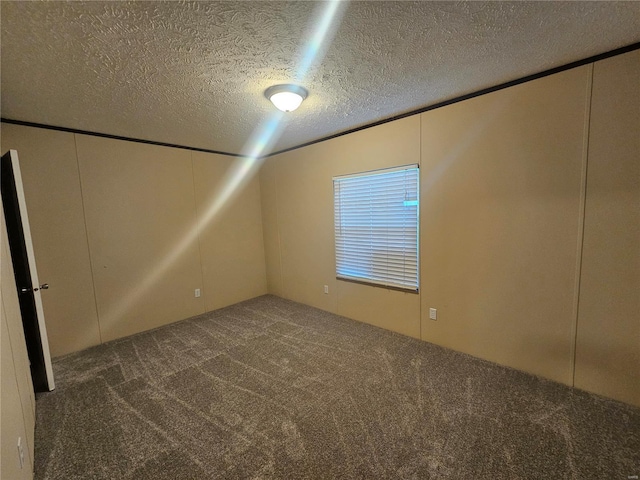 carpeted empty room with a textured ceiling