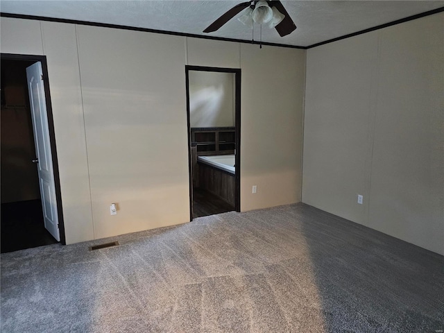 carpeted empty room with a textured ceiling and ceiling fan