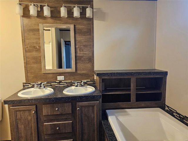 bathroom with vanity and a bath