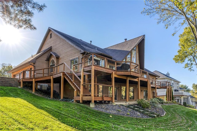 back of house with a wooden deck and a yard