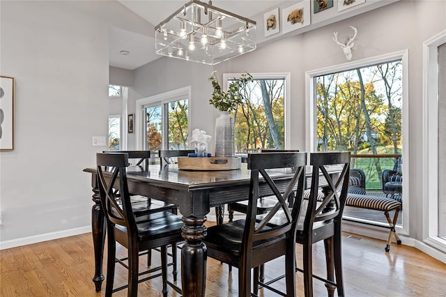 dining room featuring a notable chandelier and light wood-type flooring