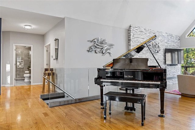 living area featuring hardwood / wood-style floors and vaulted ceiling