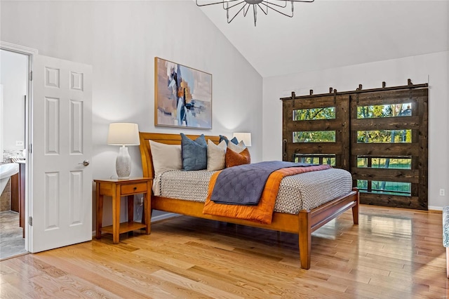 bedroom featuring high vaulted ceiling and light hardwood / wood-style flooring