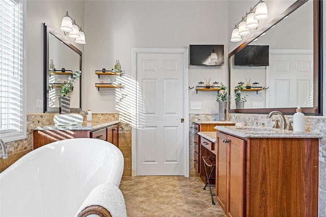 bathroom featuring vanity, tile walls, and a washtub