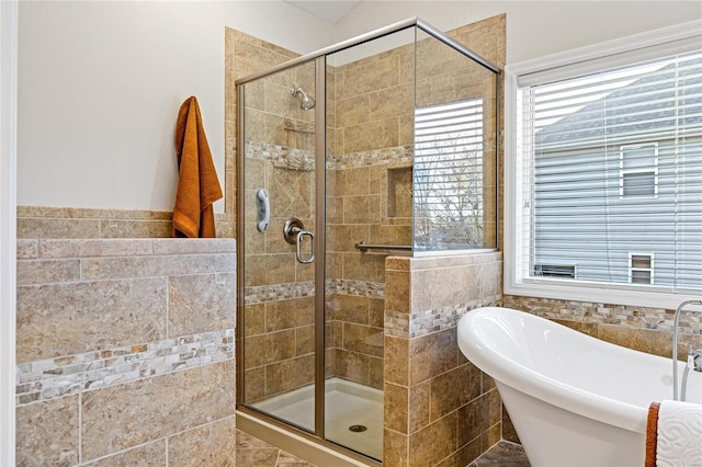 bathroom featuring tile walls and plus walk in shower