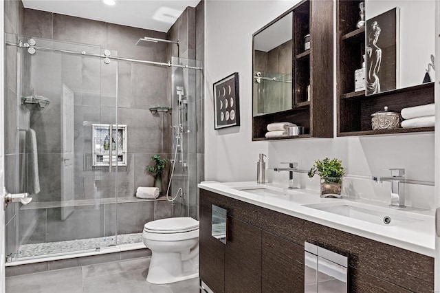 bathroom with vanity, a shower with shower door, and toilet