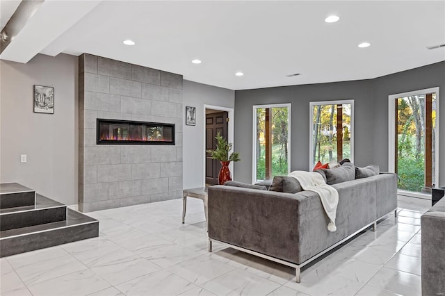 living room with a tiled fireplace