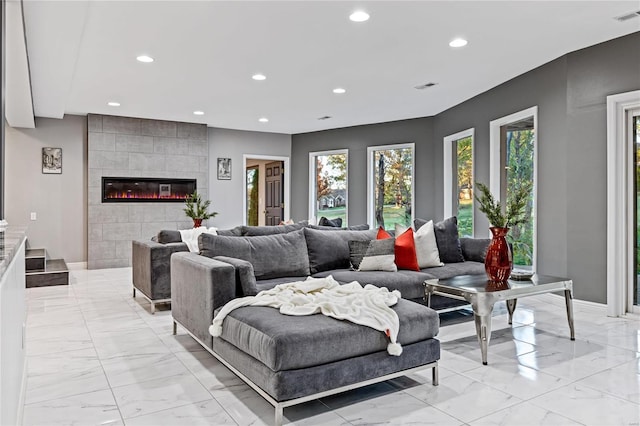 living room featuring a tile fireplace