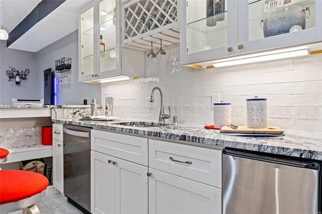 kitchen featuring sink, hanging light fixtures, white cabinets, and dishwasher