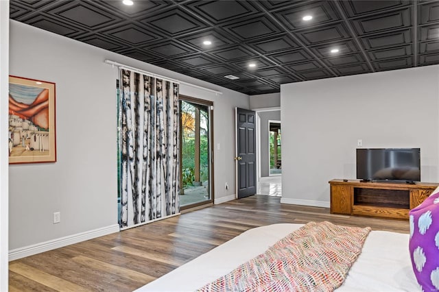 bedroom featuring access to exterior and wood-type flooring