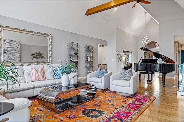 living room featuring beam ceiling, hardwood / wood-style flooring, high vaulted ceiling, and ceiling fan