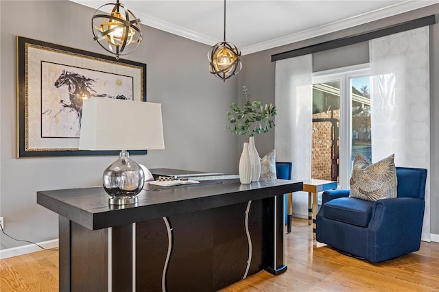 office with crown molding and light hardwood / wood-style floors