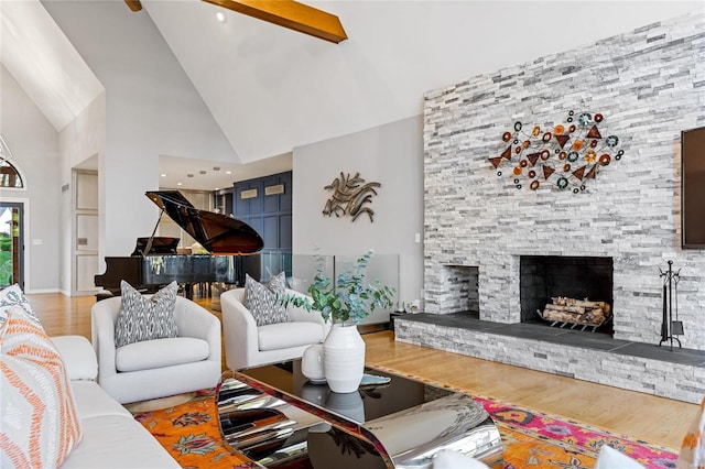 living room featuring hardwood / wood-style flooring, a fireplace, and high vaulted ceiling