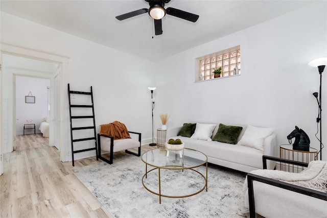 living room featuring light wood-type flooring and ceiling fan