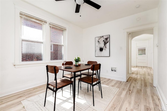 dining area featuring light wood-type flooring and ceiling fan