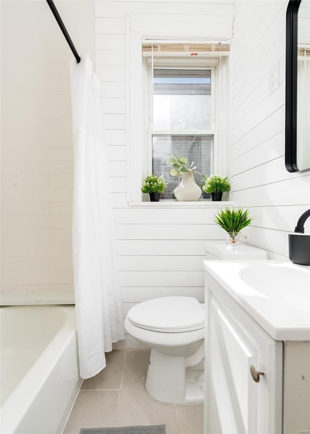 full bathroom featuring vanity, shower / tub combo, toilet, and wooden walls