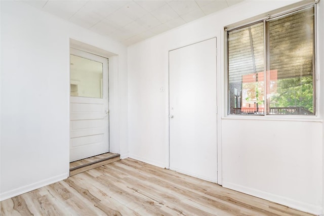 unfurnished bedroom with light hardwood / wood-style flooring and a closet