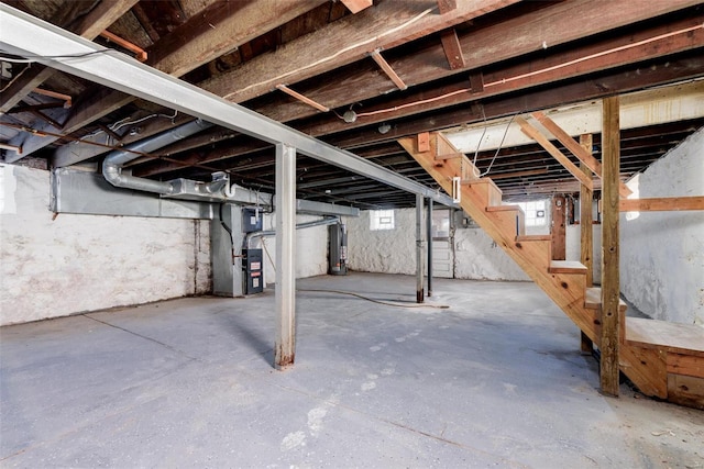 basement featuring heating unit and water heater