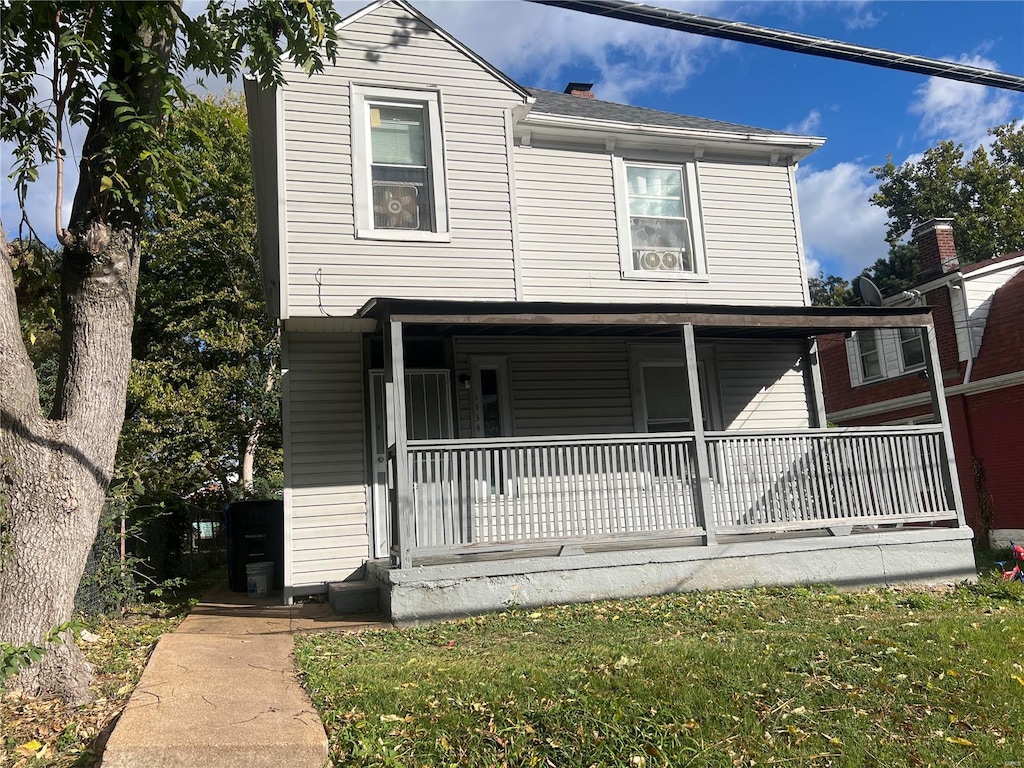 view of front of house with a front lawn and covered porch