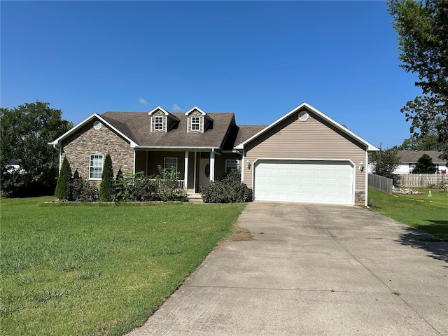 view of front of property with covered porch, a front yard, and a garage