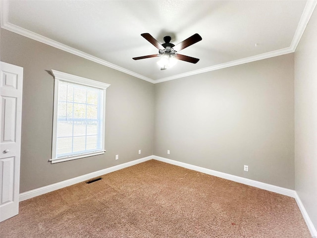 spare room with ornamental molding, carpet flooring, and ceiling fan