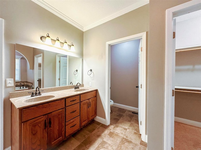 bathroom featuring vanity, toilet, and crown molding