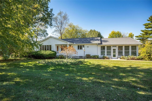 ranch-style home with a front lawn and a sunroom