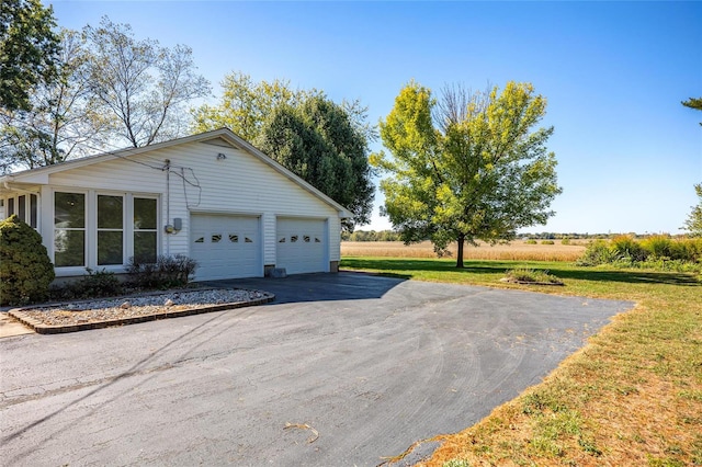 view of property exterior with a yard and a garage