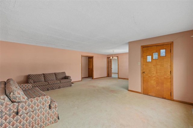 carpeted living room with a textured ceiling and a chandelier