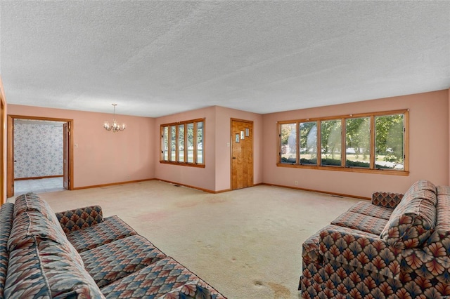 carpeted living room featuring an inviting chandelier and a textured ceiling