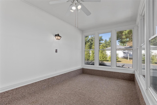 unfurnished sunroom with ceiling fan