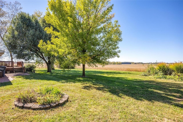 view of yard with a deck and a rural view