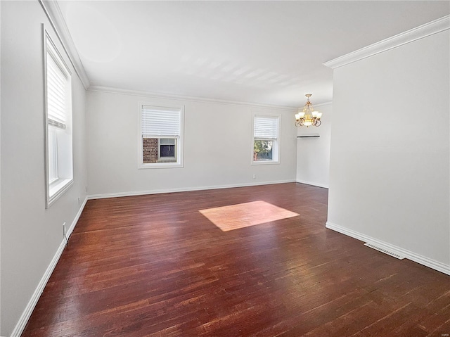 spare room featuring ornamental molding, a chandelier, and dark hardwood / wood-style floors