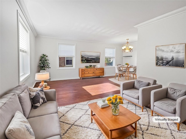 living room with ornamental molding, a notable chandelier, and hardwood / wood-style floors